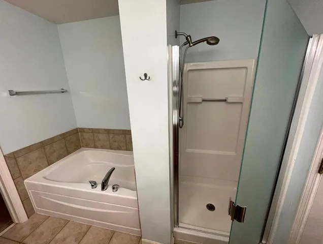 a bathroom with a tub and a shower
