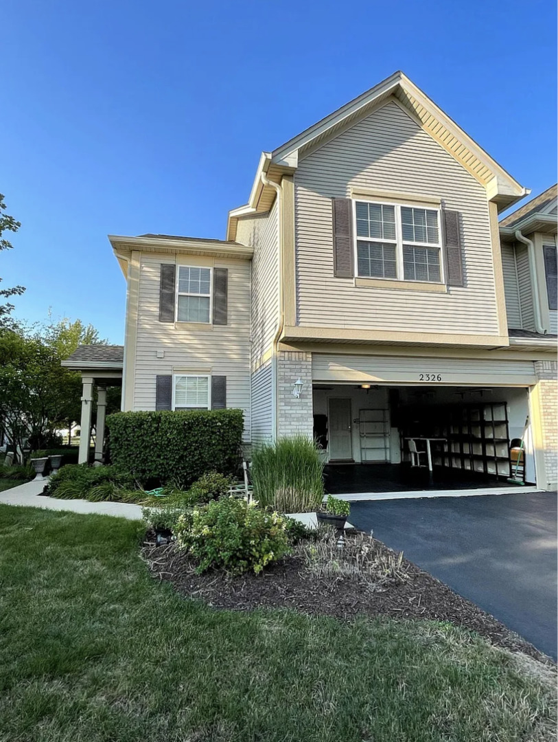 2326 Sunshine Lane Aurora, IL 60503 - Photo 2 of 27 a front view of a house with garden