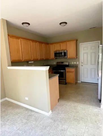 a kitchen with a stove a refrigerator and a sink