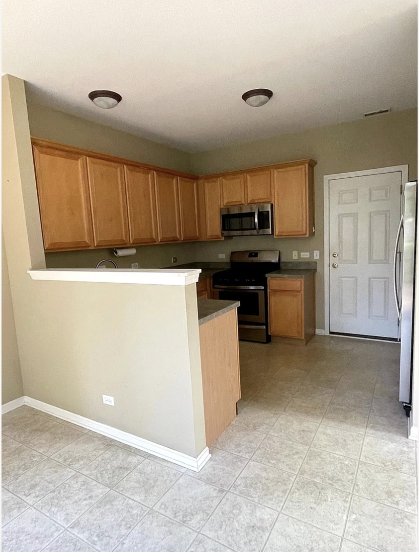2326 Sunshine Lane Aurora, IL 60503 - Photo 5 of 27 a kitchen with a stove a refrigerator and a sink