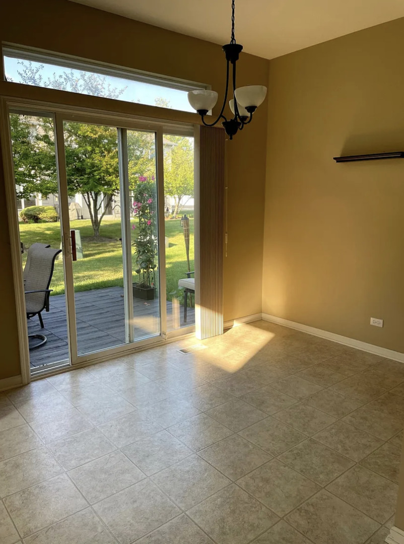 2326 Sunshine Lane Aurora, IL 60503 - Photo 10 of 27 a view of empty room with floor to ceiling window