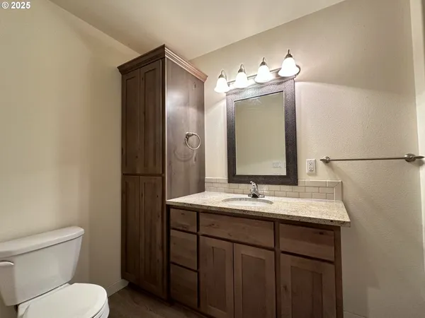 a bathroom with a sink toilet and mirror