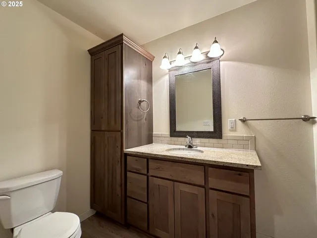 a bathroom with a sink toilet and mirror