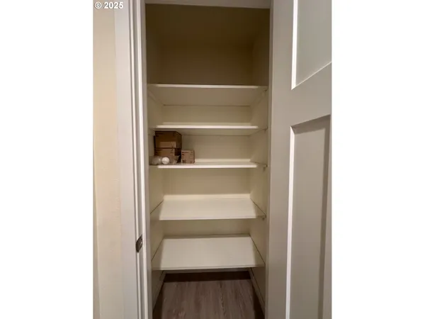 a view of walk in closet with empty racks