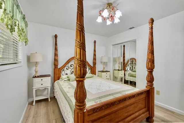 a bed room with a bed mirror and a window