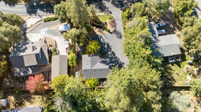an aerial view of a house with a yard and garden