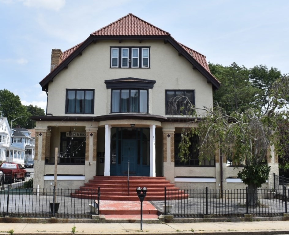 a front view of a house with a small yard