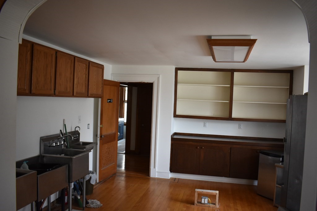 321 North Main Street Fall River, MA 02720 - Photo 19 of 38 a kitchen with a refrigerator and cabinets