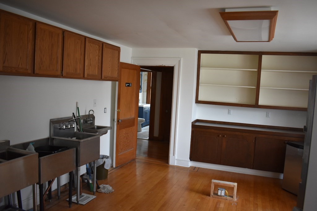 321 North Main Street Fall River, MA 02720 - Photo 20 of 38 a kitchen with stainless steel appliances a cabinets and wooden floor