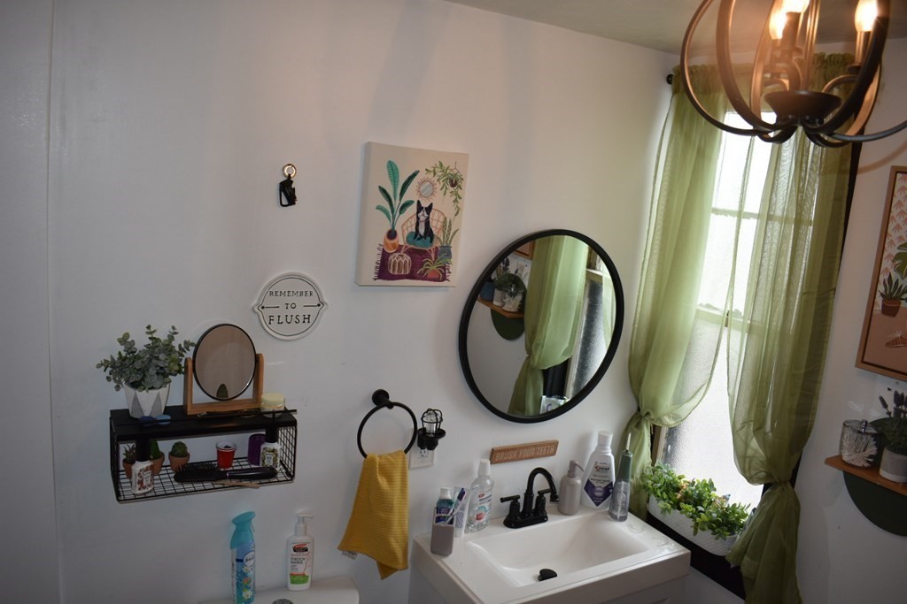 321 North Main Street Fall River, MA 02720 - Photo 37 of 38 a bathroom with a sink mirror and vanity