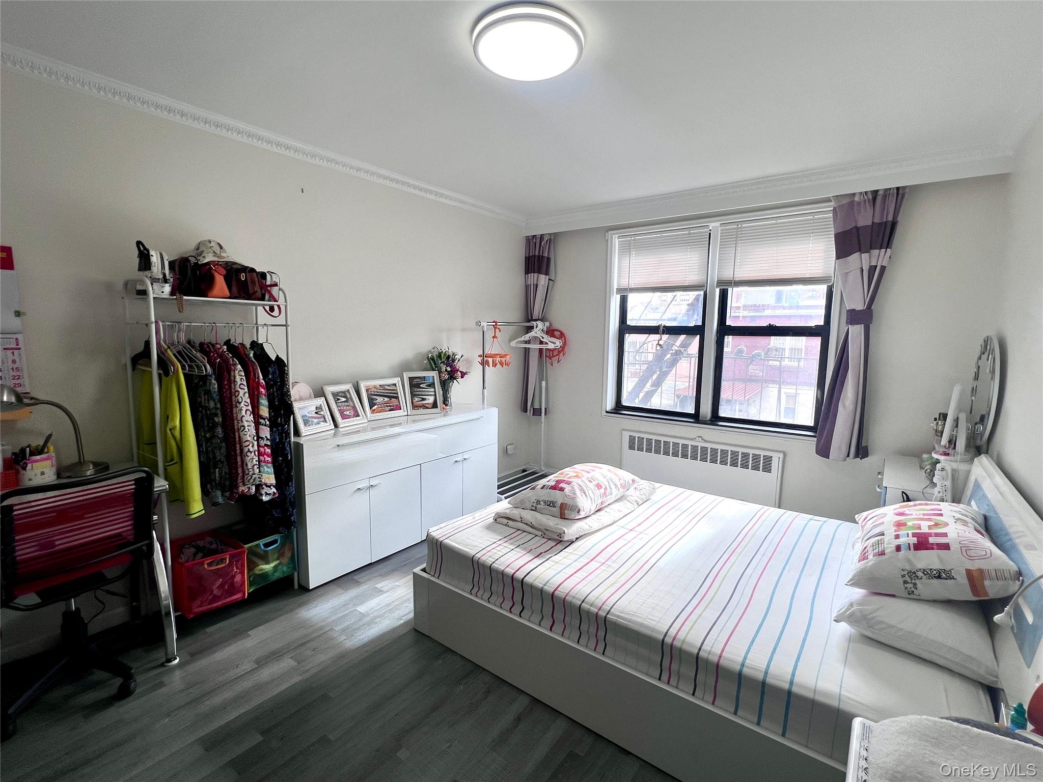 102-32 65th Avenue, Unit B37 Queens, NY 11375 - Photo 13 of 23 a bedroom with a bed and a window