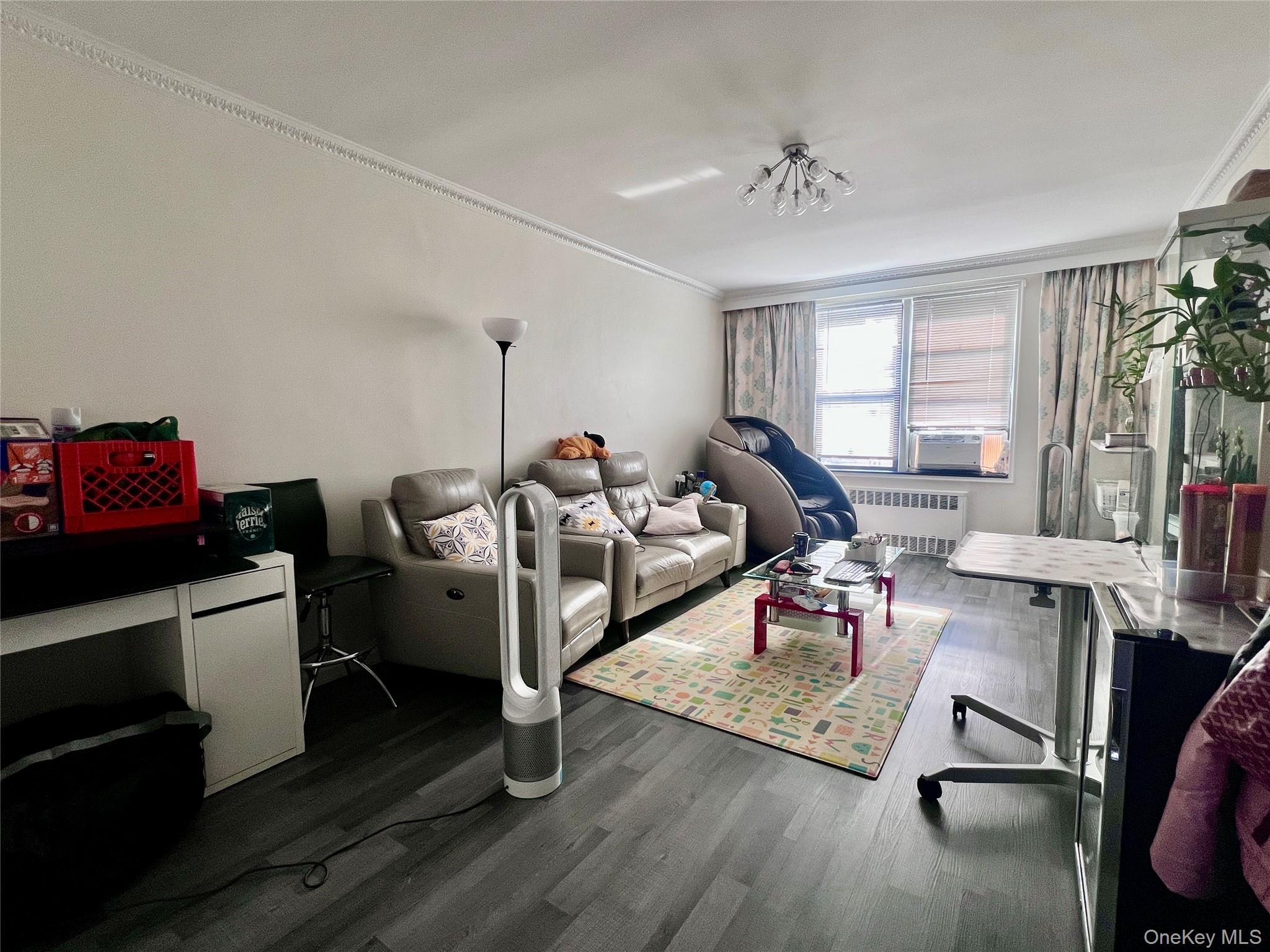102-32 65th Avenue, Unit B37 Queens, NY 11375 - Photo 2 of 23 a living room with furniture hard wood floor and a window