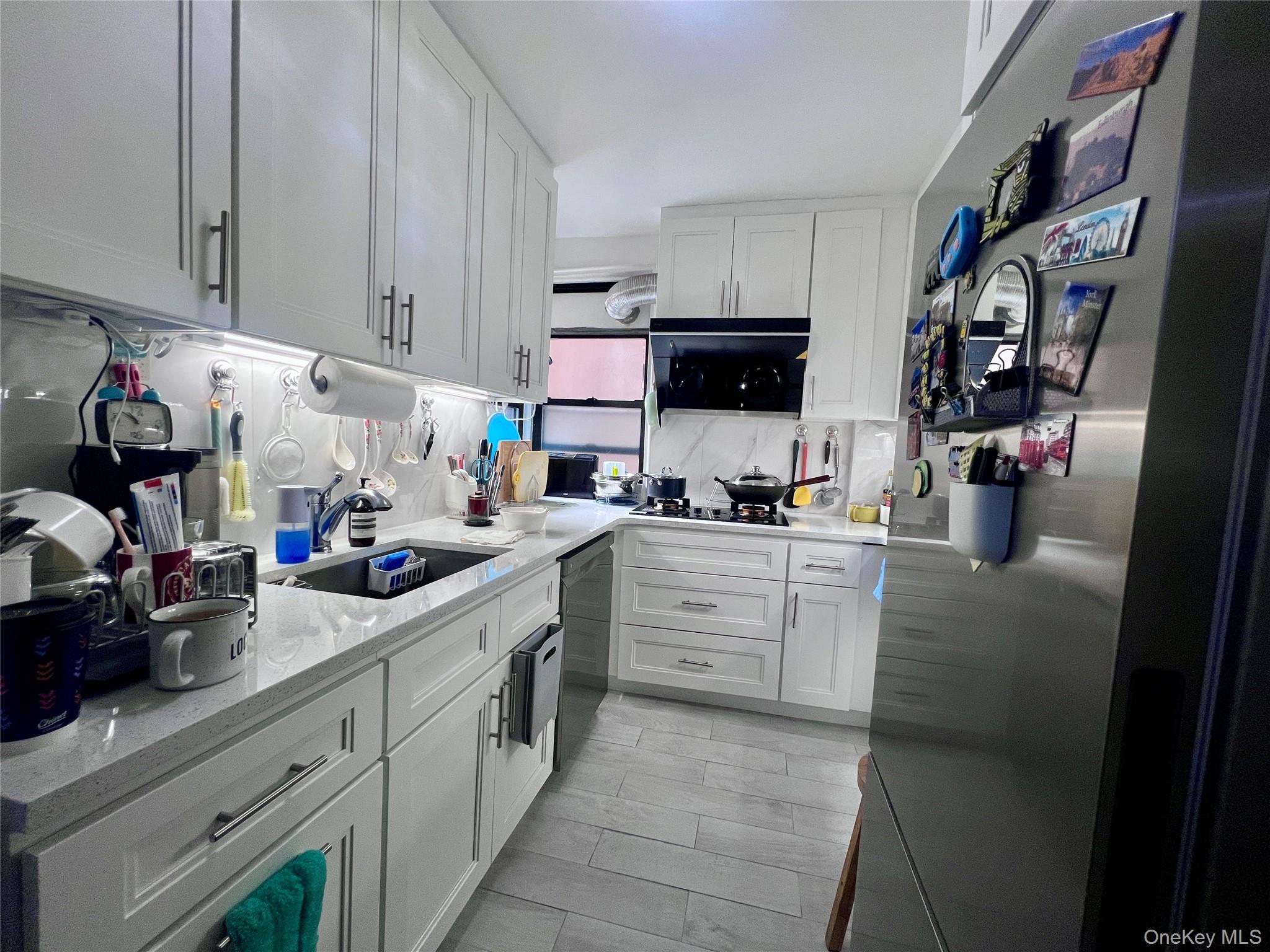 102-32 65th Avenue, Unit B37 Queens, NY 11375 - Photo 10 of 23 a kitchen with cabinets and a stove