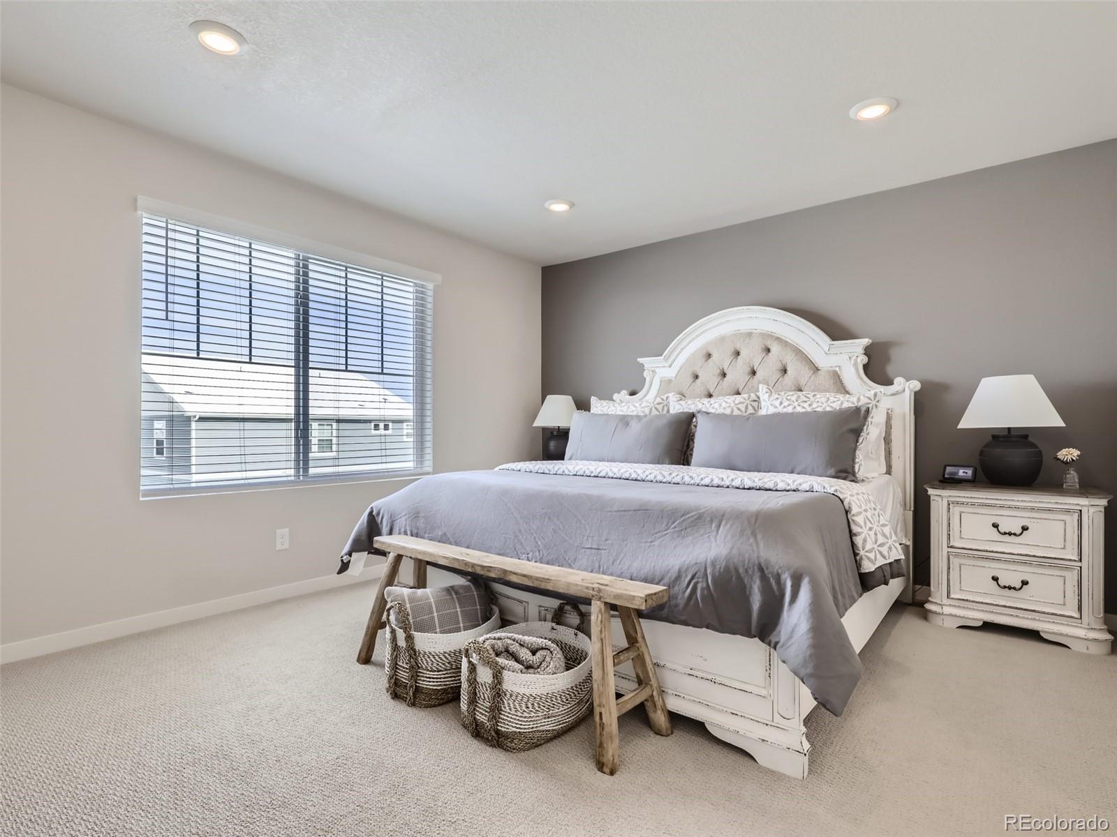 4495 Riviera Court Aurora, CO 80019 - Photo 11 of 28 a spacious bedroom with a bed and a large window