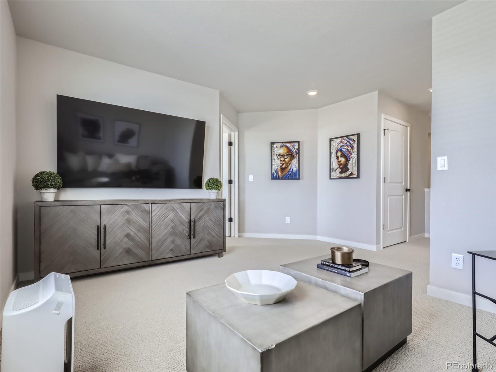 4495 Riviera Court Aurora, CO 80019 - Photo 19 of 28 a living room with furniture and a flat screen tv