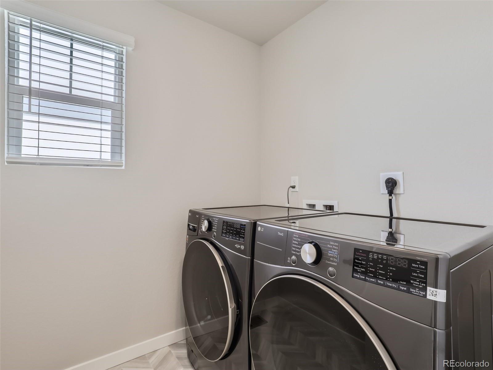 4495 Riviera Court Aurora, CO 80019 - Photo 24 of 28 a utility room with dryer and washer