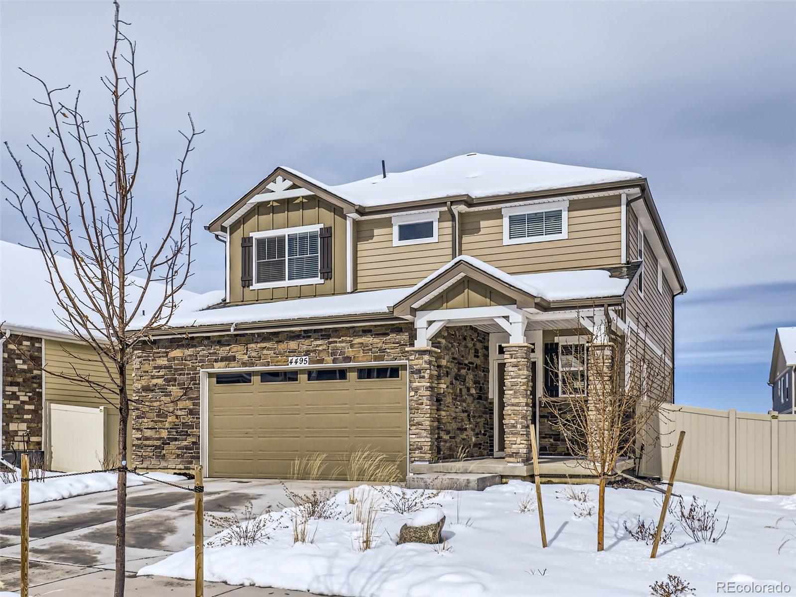 4495 Riviera Court Aurora, CO 80019 - Photo 26 of 28 a front view of a house with a yard