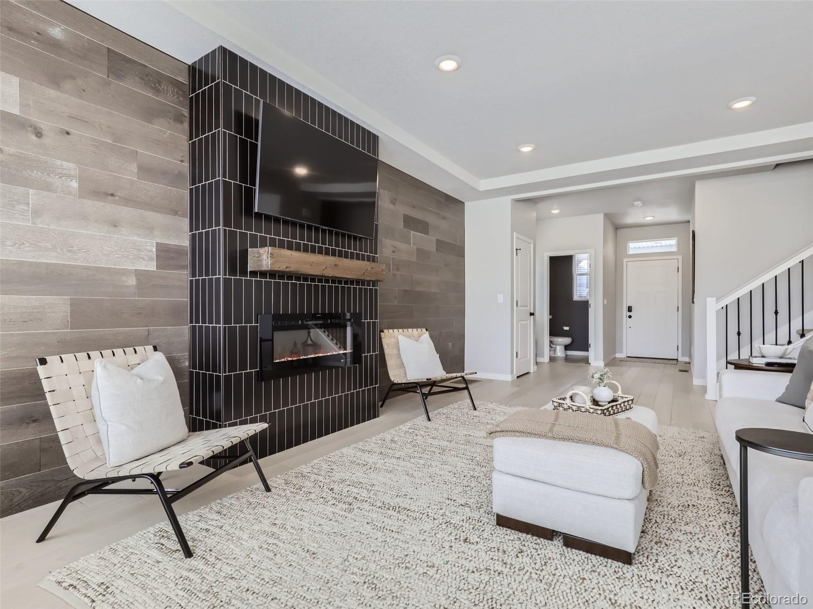 4495 Riviera Court Aurora, CO 80019 - Photo 7 of 28 a living room with furniture and a fireplace