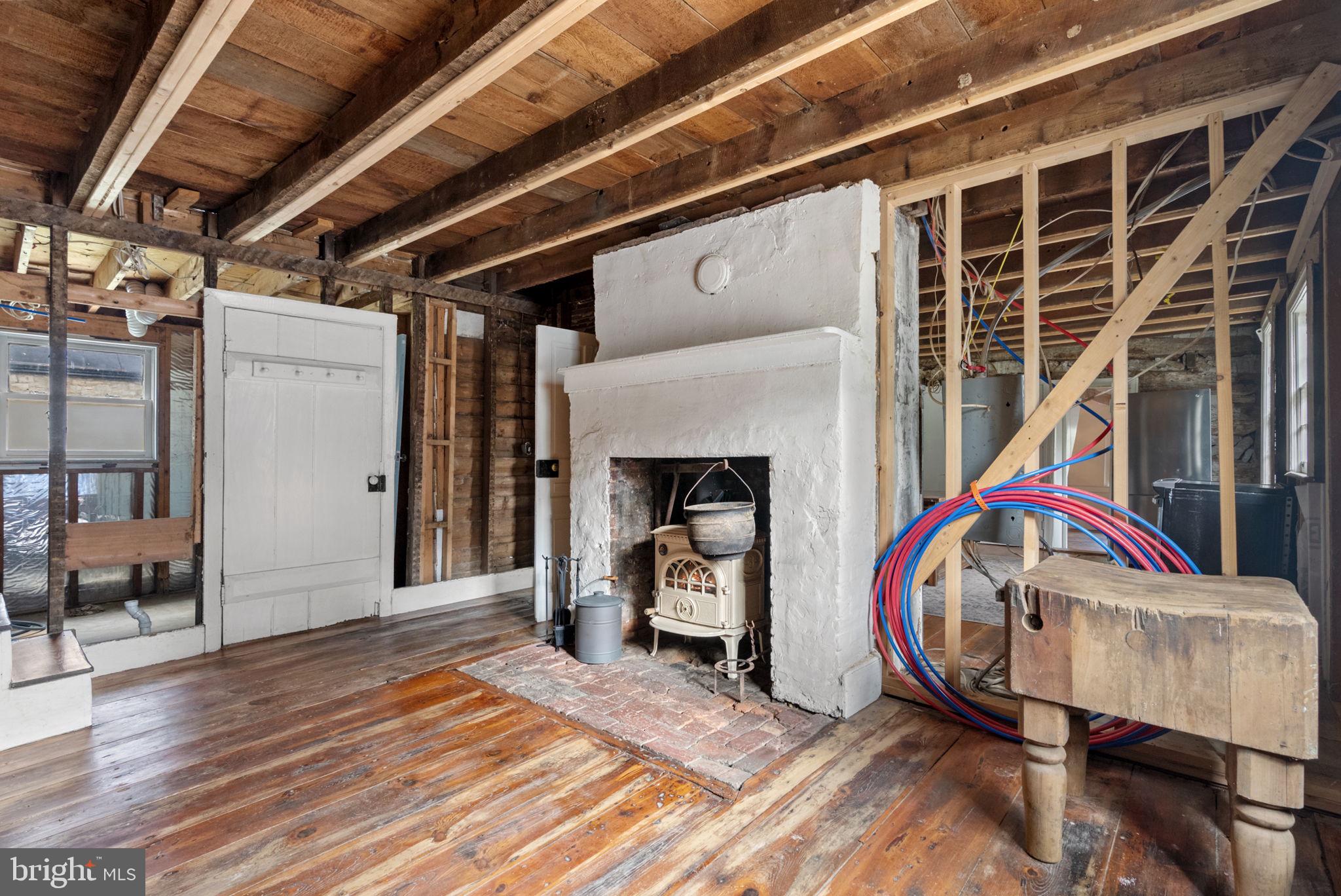 7379 Queen Street Middleway, WV 25430 - Photo 17 of 58 a view of an empty room with wooden floor and a fireplace