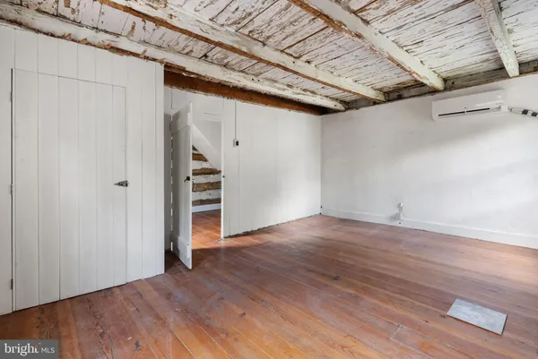 a view of a livingroom with wooden floor and cabinet
