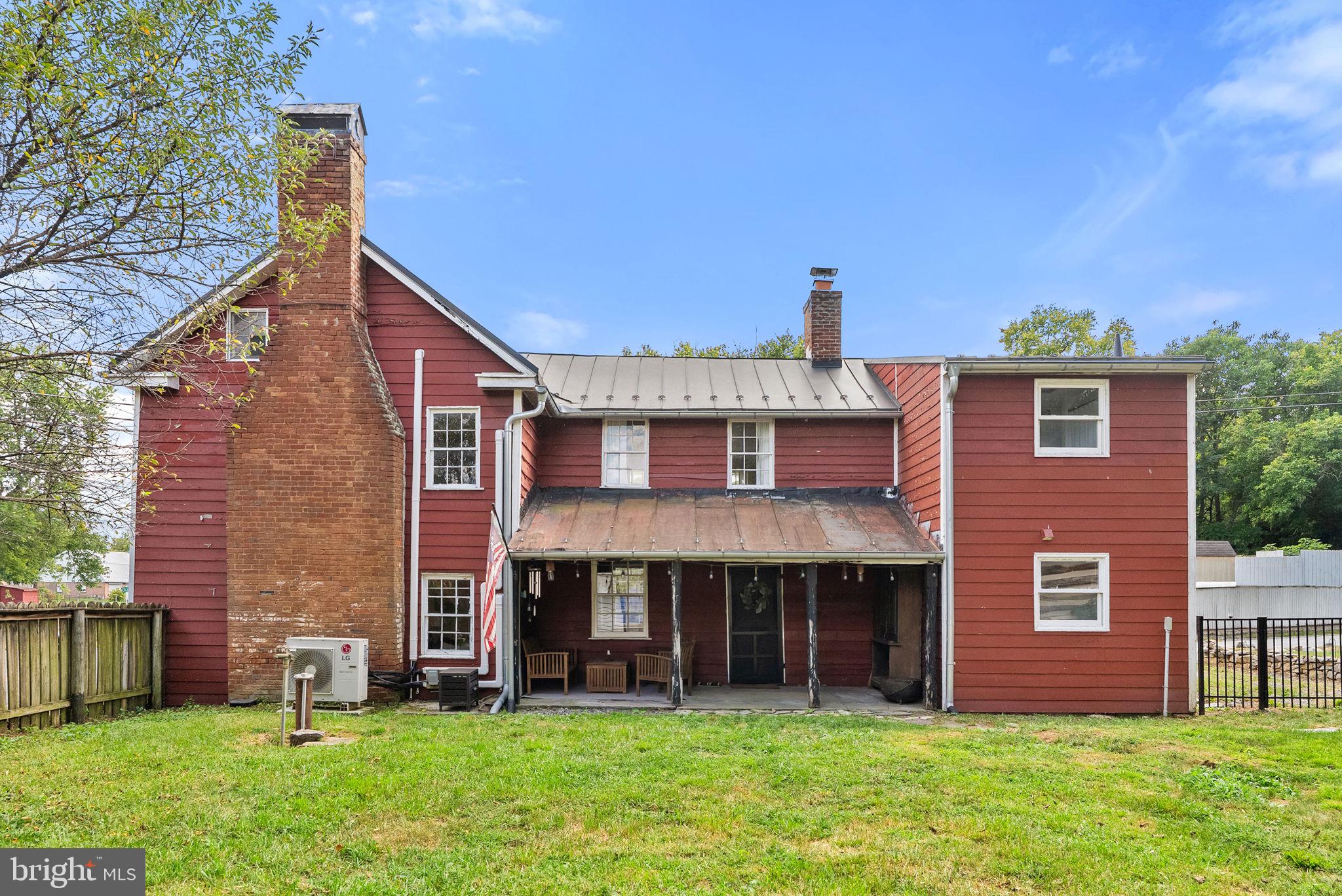 7379 Queen Street Middleway, WV 25430 - Photo 46 of 58 a view of a brick house with a yard and large tree