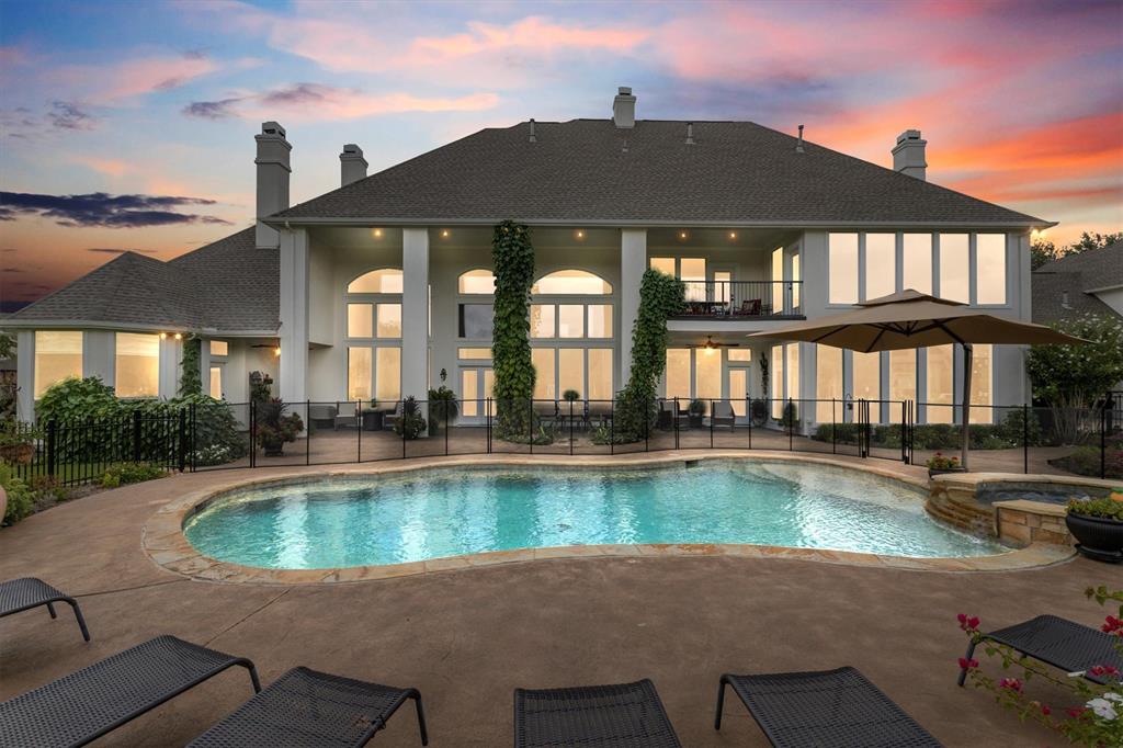 a view of a house with swimming pool and a porch