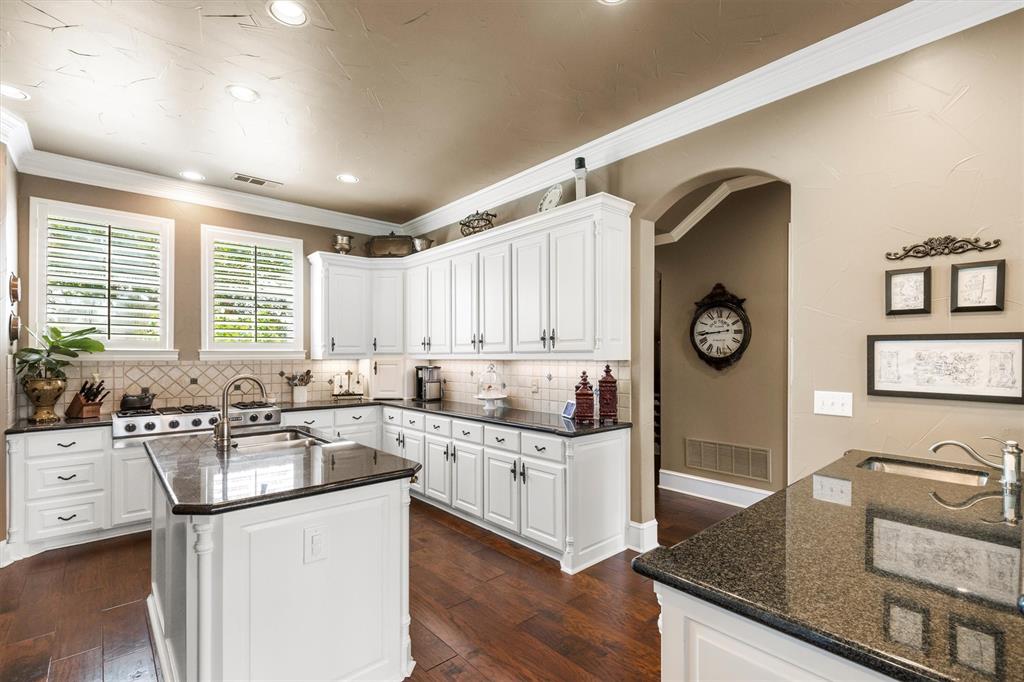 539 Ridge Point Drive Heath, TX 75126 - Photo 12 of 29 a kitchen with a sink stove top oven and cabinets