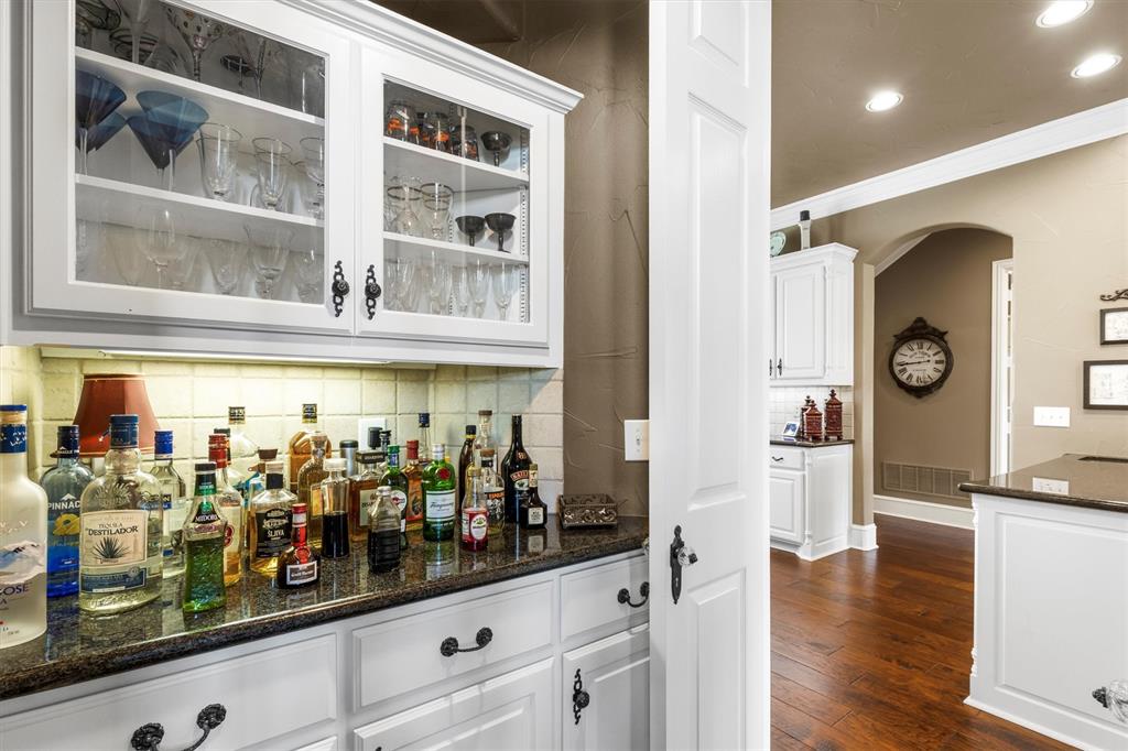 539 Ridge Point Drive Heath, TX 75126 - Photo 14 of 29 a kitchen with stainless steel appliances kitchen island counter space and wooden floor