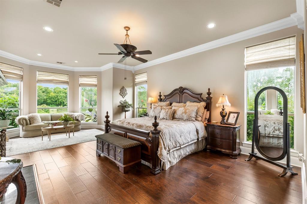 539 Ridge Point Drive Heath, TX 75126 - Photo 16 of 29 a spacious bedroom with a bed a couch and a large window