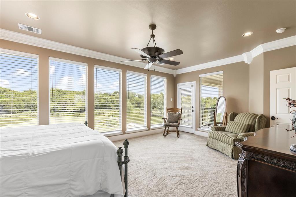 539 Ridge Point Drive Heath, TX 75126 - Photo 17 of 29 a spacious bedroom with a large bed and a large window