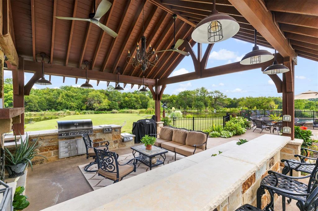 539 Ridge Point Drive Heath, TX 75126 - Photo 24 of 29 a view of a patio with chairs and table under an umbrella