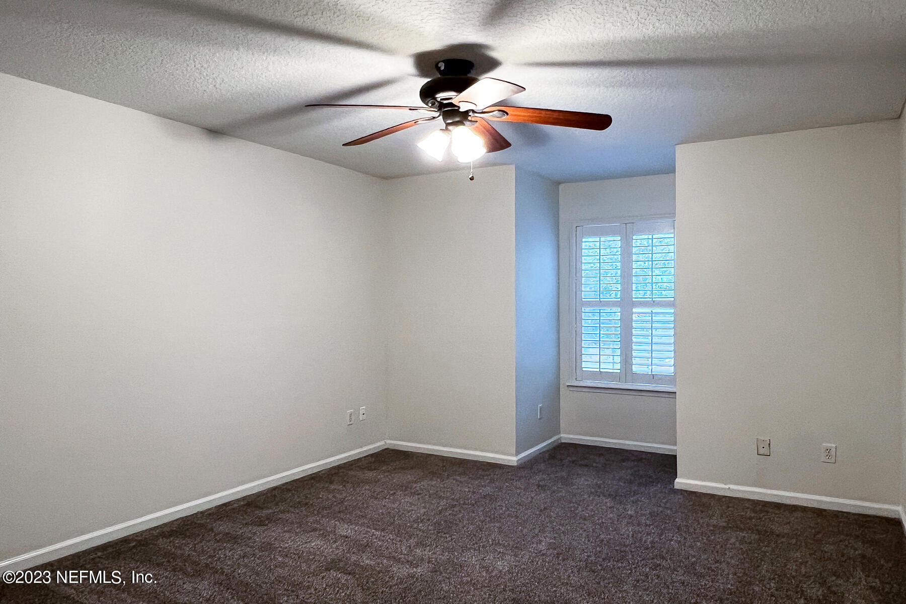 5260 Collins Road, Unit 603 Jacksonville, FL 32244 - Photo 13 of 23 a view of an empty room with wooden floor and windows