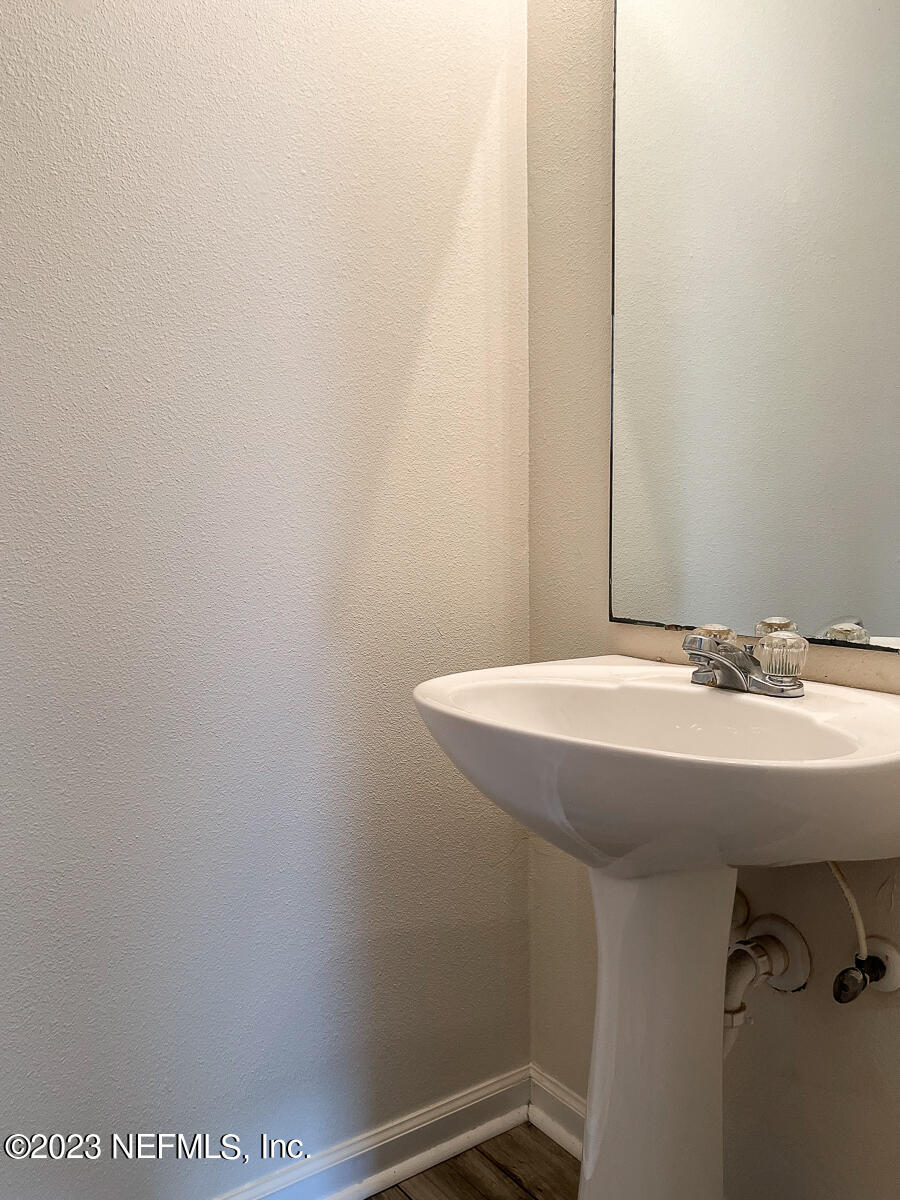 5260 Collins Road, Unit 603 Jacksonville, FL 32244 - Photo 8 of 23 a bathroom with a sink and mirror