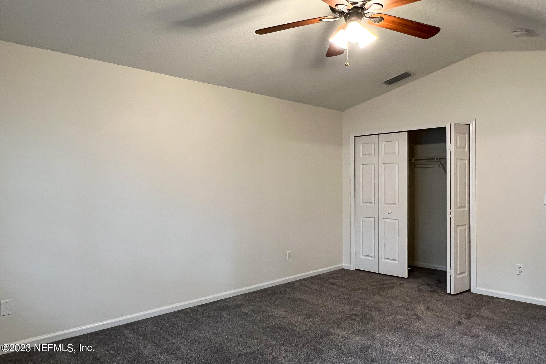 5260 Collins Road, Unit 603 Jacksonville, FL 32244 - Photo 10 of 23 an empty room with a ceiling fan and a fan