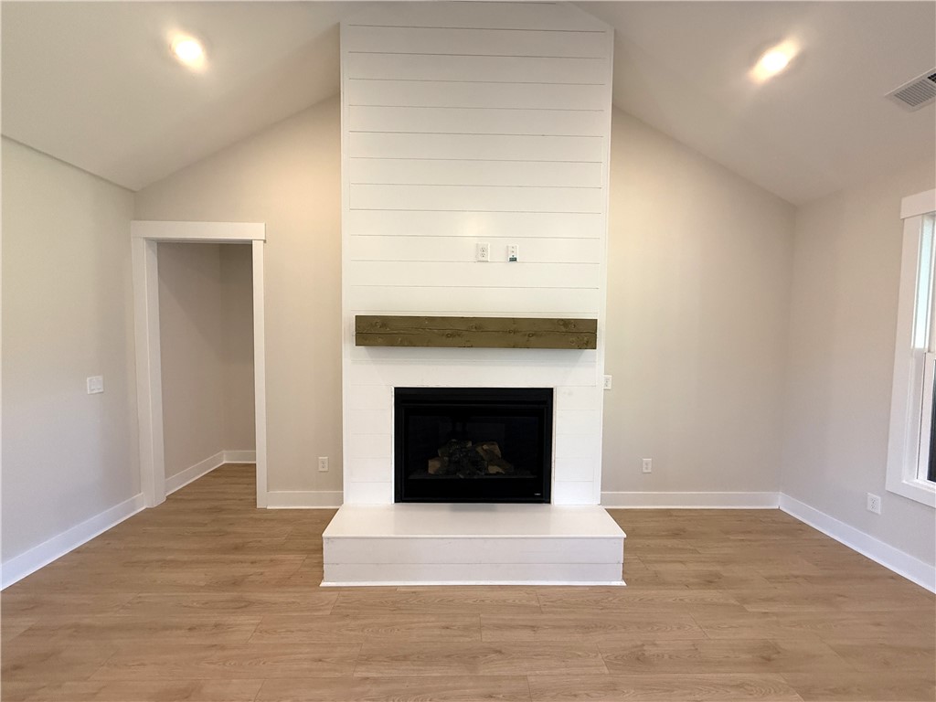 504 Tilman Court Anderson, SC 29621 - Photo 7 of 28 This inviting space features vaulted ceilings and a charming fireplace, creating a warm ambiance.