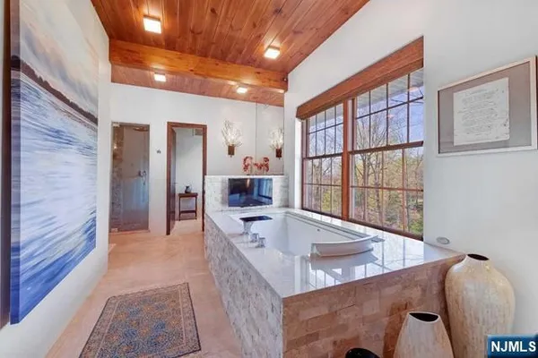 a dining hall with stainless steel appliances granite countertop furniture and a fireplace