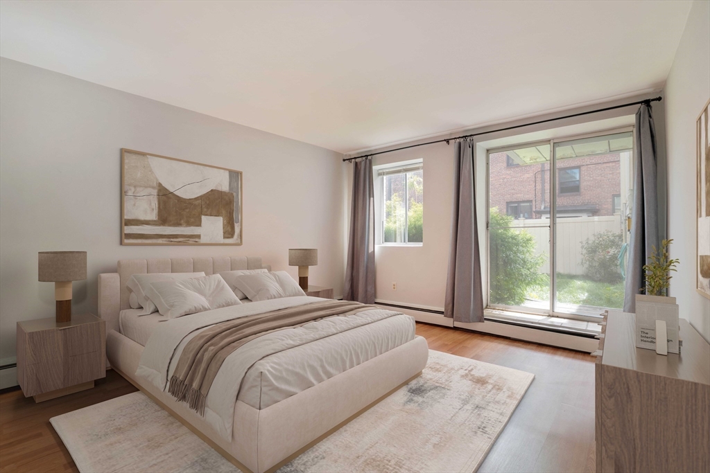 123 Sewall Avenue, Unit LC Brookline, MA 02446 - Photo 1 of 32 a bedroom with a large bed and a large window