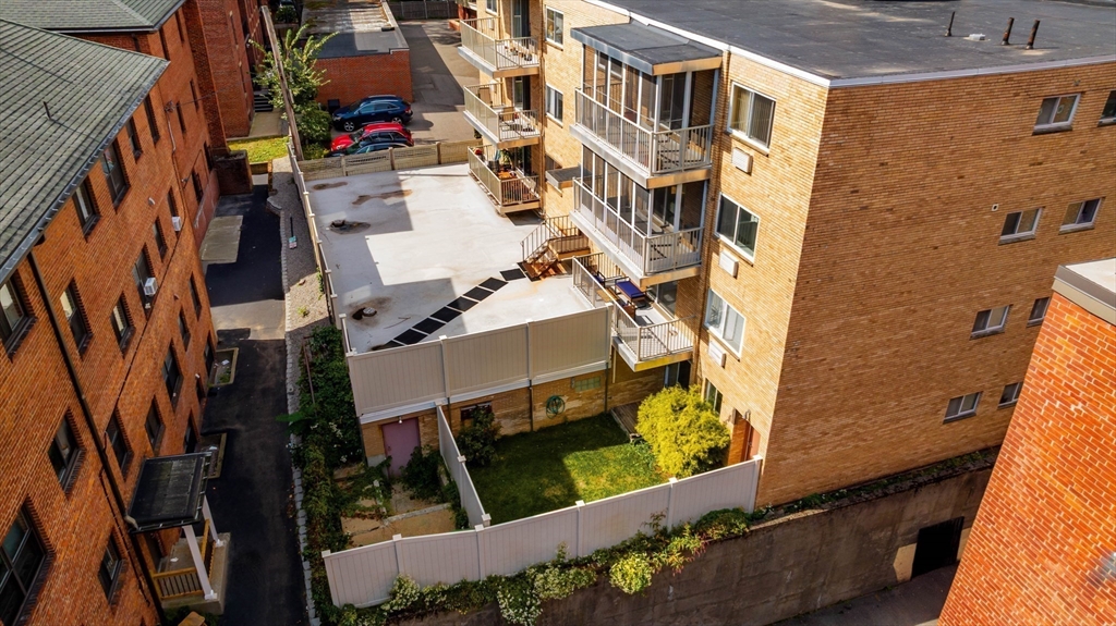 123 Sewall Avenue, Unit LC Brookline, MA 02446 - Photo 19 of 32 an aerial view of a residential apartment building with a yard