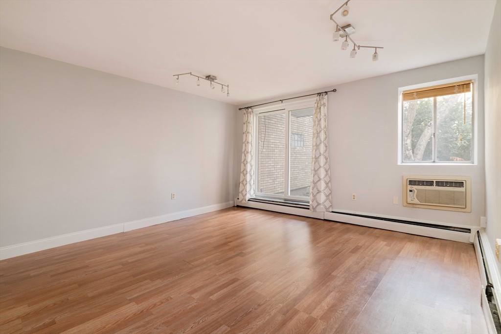 123 Sewall Avenue, Unit LC Brookline, MA 02446 - Photo 28 of 32 a view of an empty room with wooden floor and a window