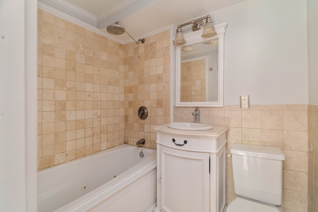 123 Sewall Avenue, Unit LC Brookline, MA 02446 - Photo 8 of 32 a bathroom with a sink a toilet and shower