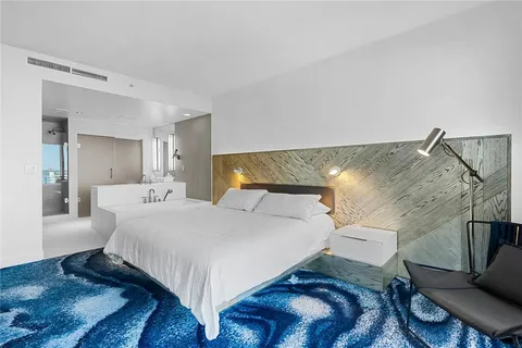 a bedroom with a bed and a mirror