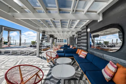 a outdoor living with dining table and a chandelier