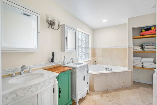a bathroom with a granite countertop sink mirror bathtub and shower