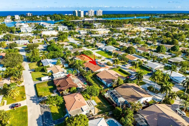 an aerial view of residential houses with outdoor space and street view