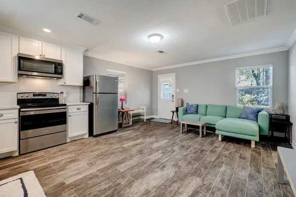 a living room with furniture and a flat screen tv