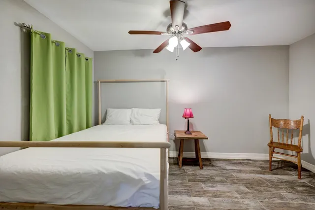 a bedroom with a bed and a chandelier