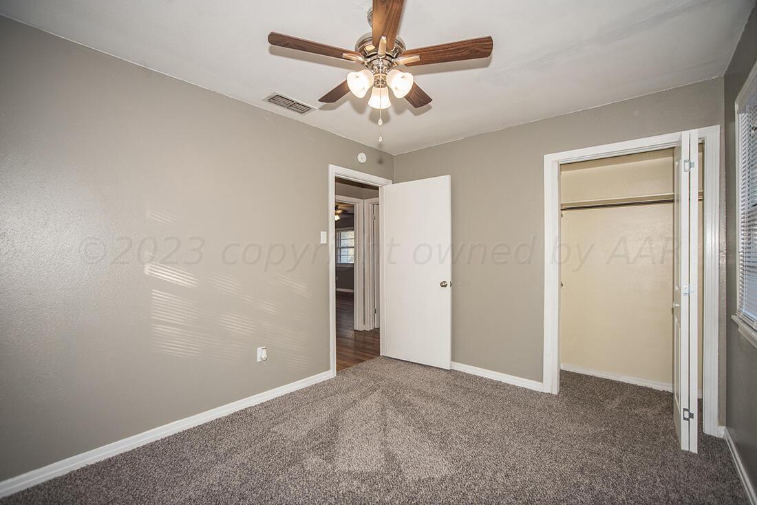 4008 Gables Street Amarillo, TX 79110 - Photo 11 of 15 a view of an empty room and chandelier fan