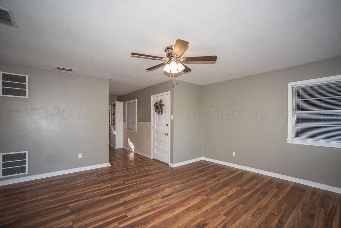 4008 Gables Street Amarillo, TX 79110 - Photo 3 of 15 a view of an empty room with window and wooden floor
