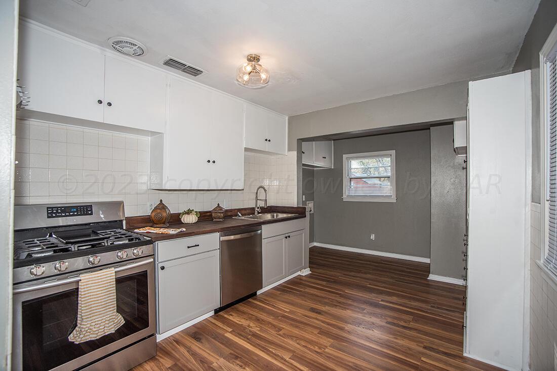 4008 Gables Street Amarillo, TX 79110 - Photo 4 of 15 a kitchen with granite countertop a stove and a sink