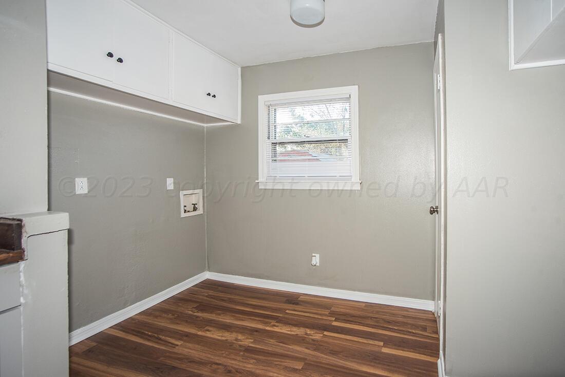 4008 Gables Street Amarillo, TX 79110 - Photo 5 of 15 a view of an empty room with wooden floor and a window